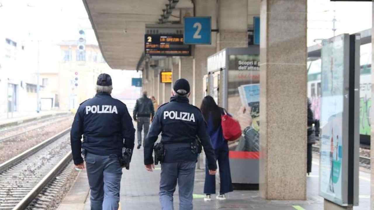 Due poliziotti di spalle alla stazione treni