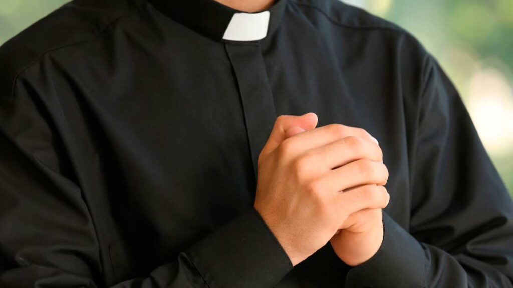 Un sacerdote con le mani giunte