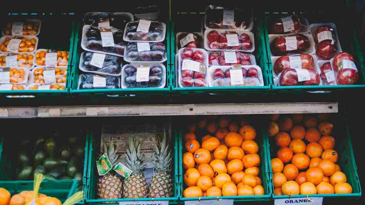 Insalata e frutta in buste di plastica esposte al supermercato