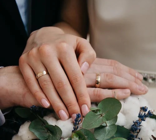 Un primo piano delle mani di due sposi a
un matrimonio